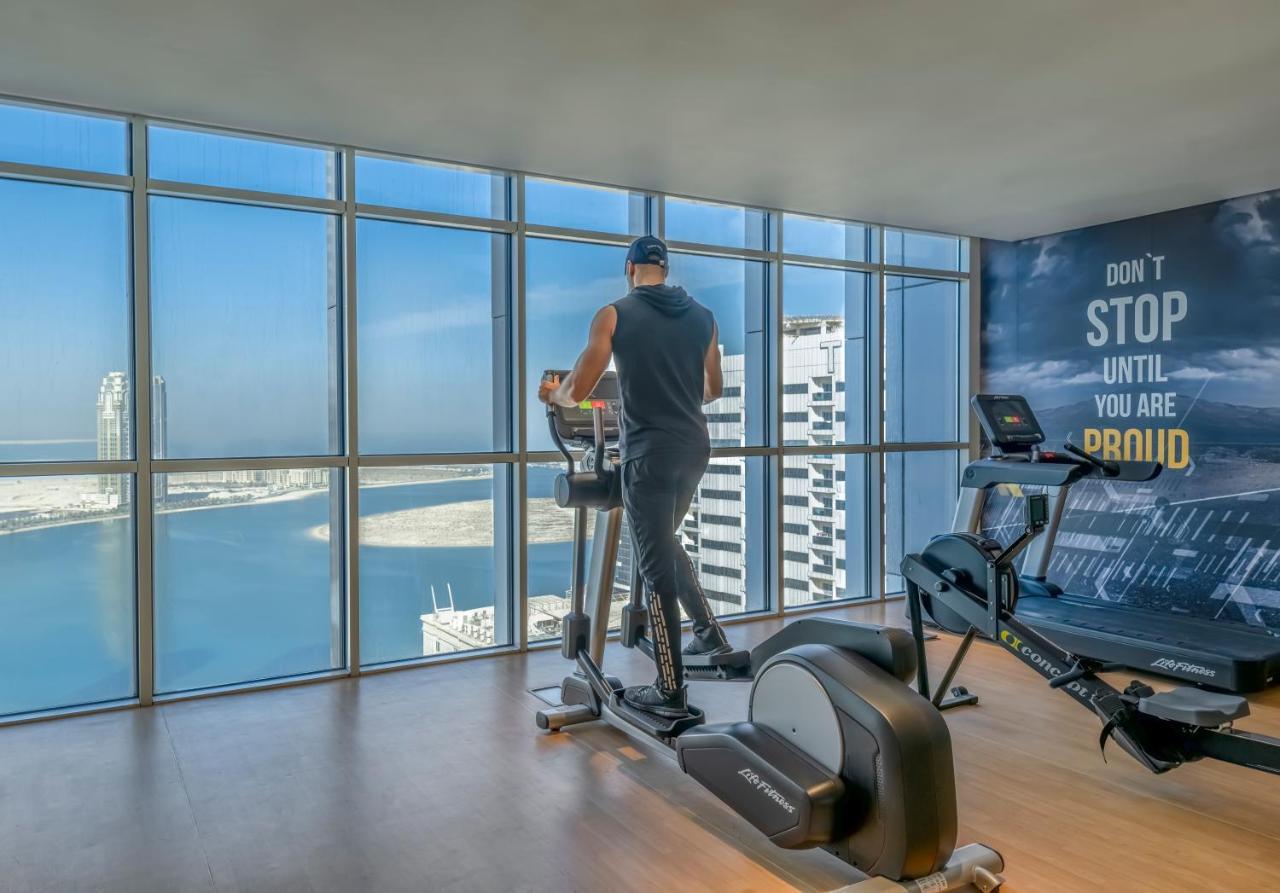 Pullman Sharjah Hotell Exteriör bild A man using a cross trainer